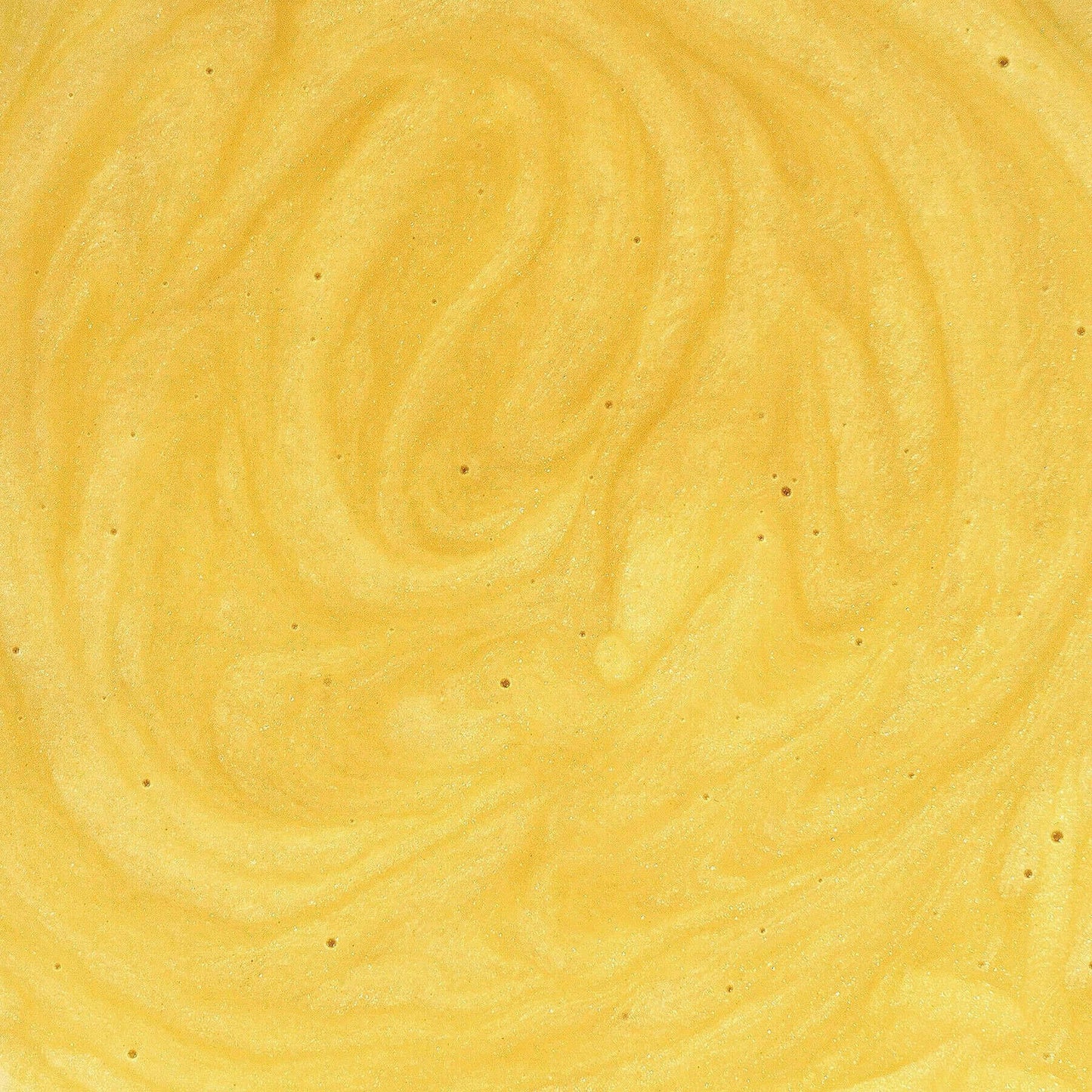 Creamy yellow swirled texture resembling delicious custard in close-up view.