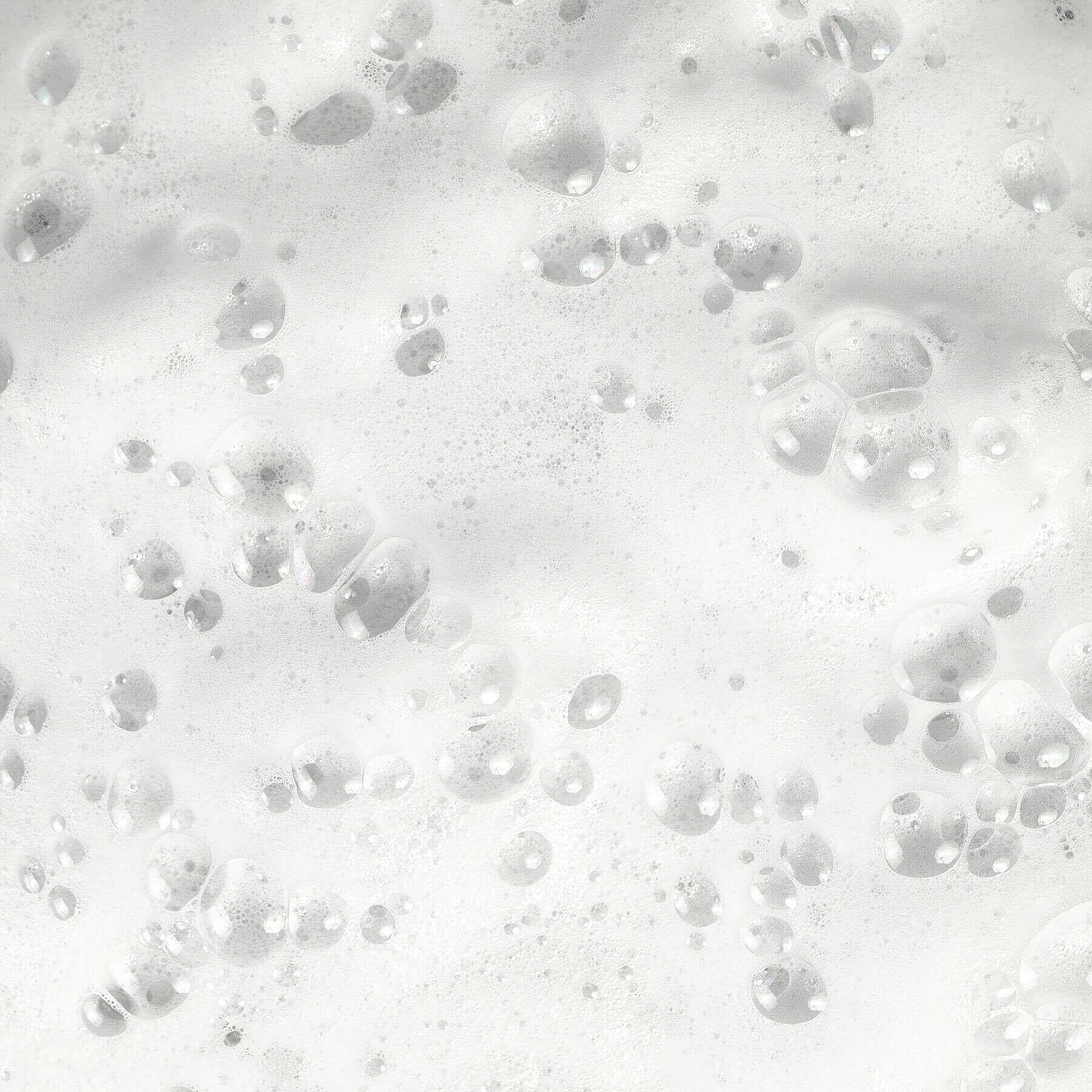 White foamy bubbles floating on a bubbly surface, creating a frothy and clean appearance.