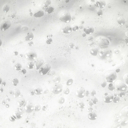 White foamy bubbles floating on a bubbly surface, creating a frothy and clean appearance.