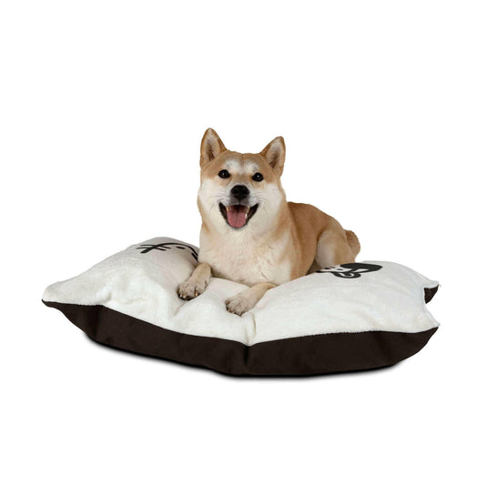 Cute dog lying on a comfy cushion with a happy expression