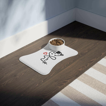 Adorable pet food bowl on cute white mat with cartoon cat sketch and heart, placed on dark wooden floor in cozy room.